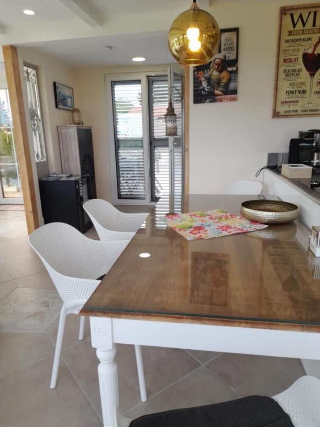 Wooden dining table under a golden pendant light