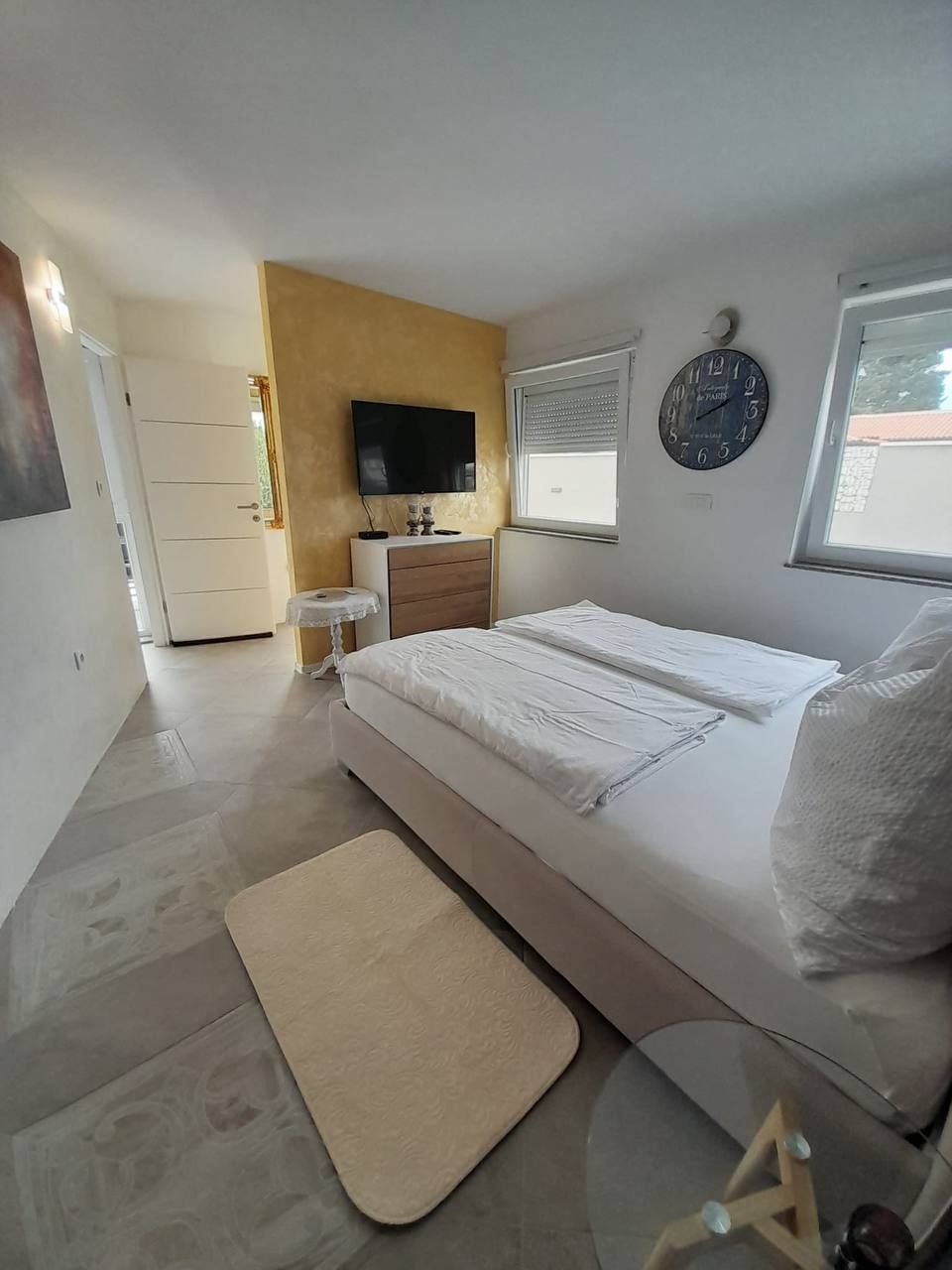 Bedroom with window and wall clock