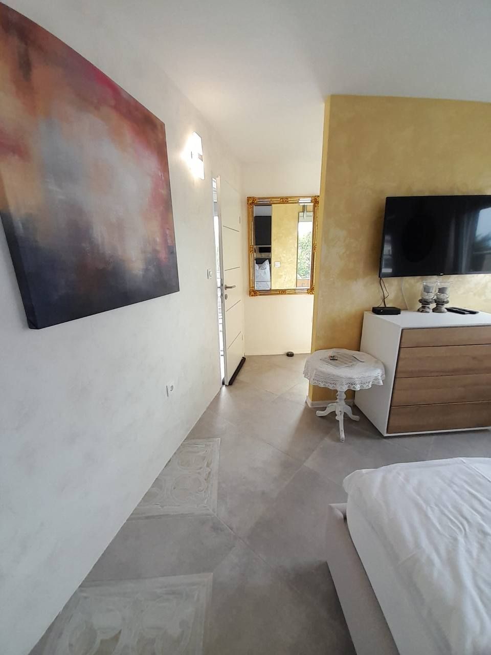 Bedroom with wall art and TV