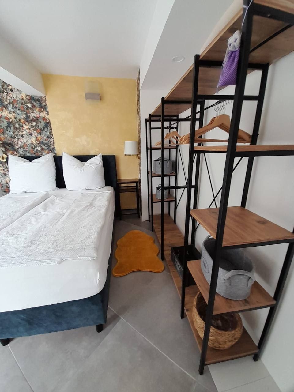 Bedroom with double bed and open shelving