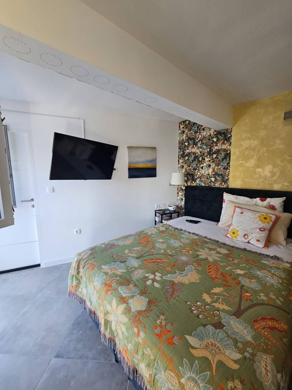 Bedroom with smart TV and floral feature wall