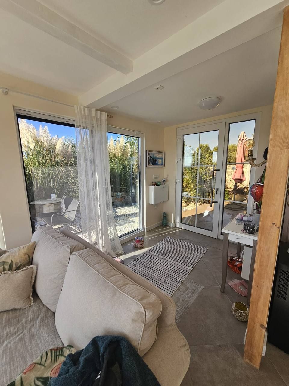 Living room with sofa and floor-to-ceiling windows