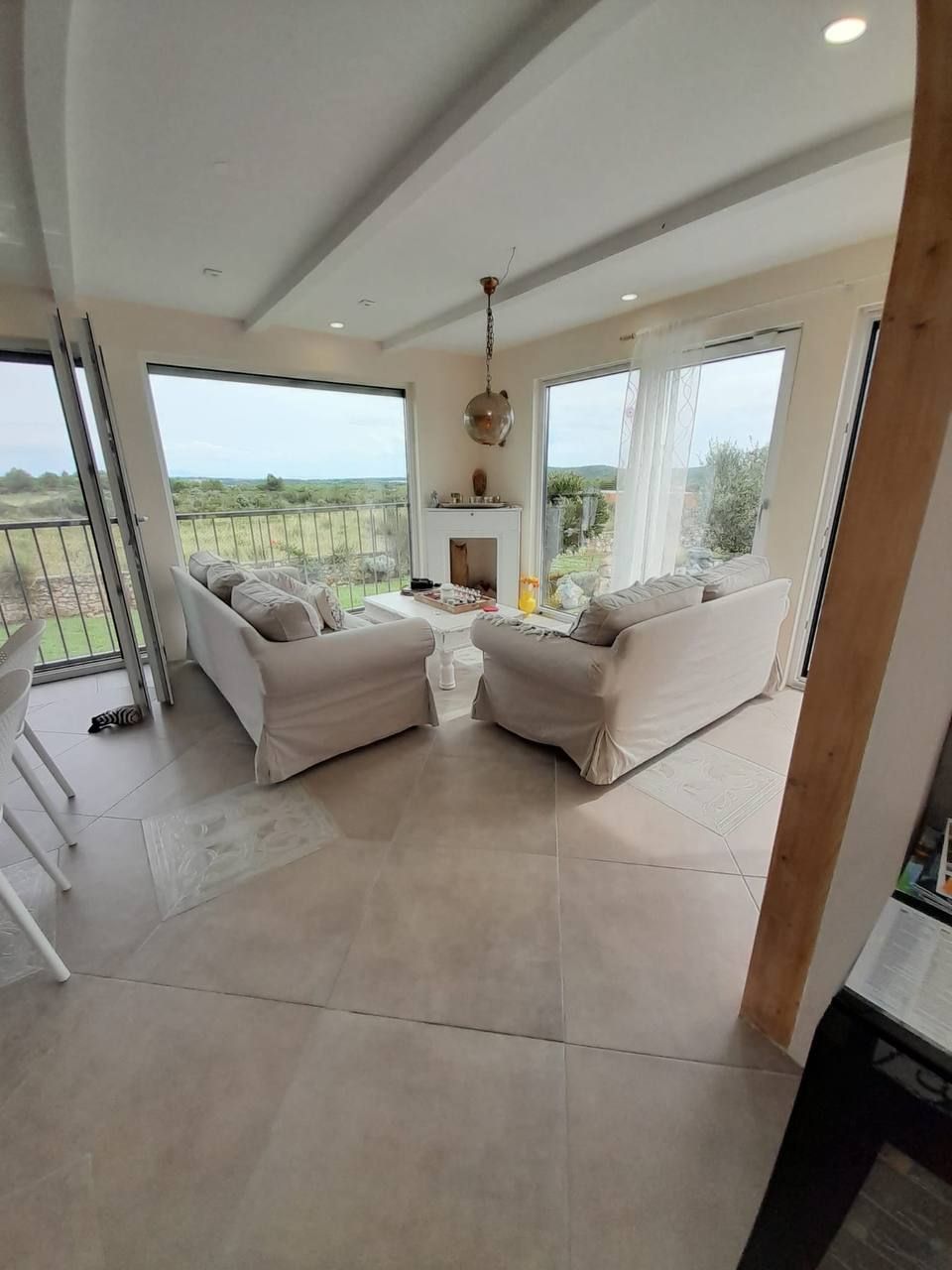 Living room with panoramic window and fireplace